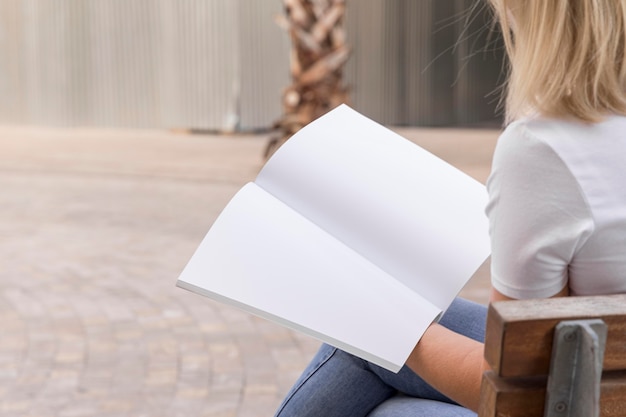 Female on street reading book