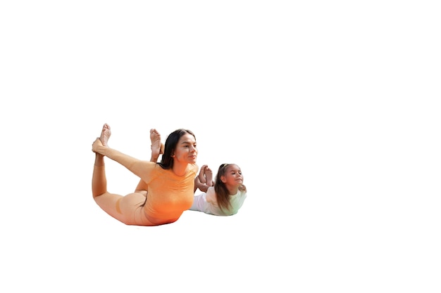 Female yoga instructor doing meditation with young girl