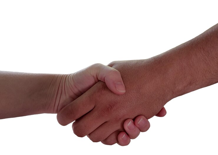PSD firm handshake between two hands on a white background closeup photography