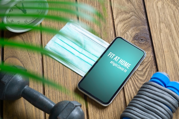 Fit At Home, Здоровый дома в течение карантинных времен в концепции пандемии коронавируса. Макет мобильного телефона для Be Active во время вирусной пандемии. Бой Ковид-19