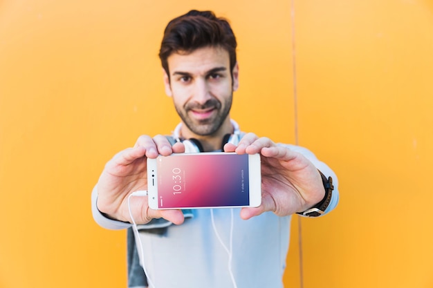 PSD fitness mockup with man showing smartphone