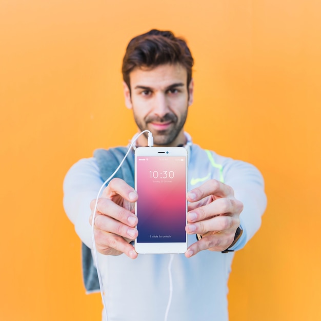 Fitness mockup with man showing smartphone