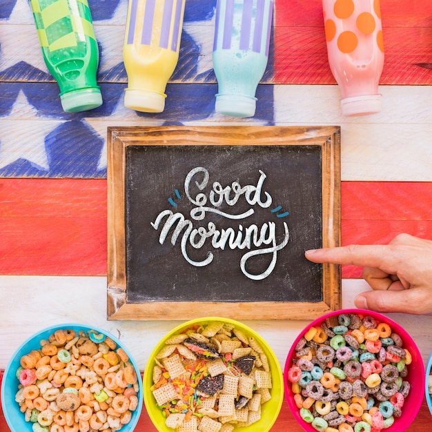 Flat lay of arrangement of cereals and chalkboard