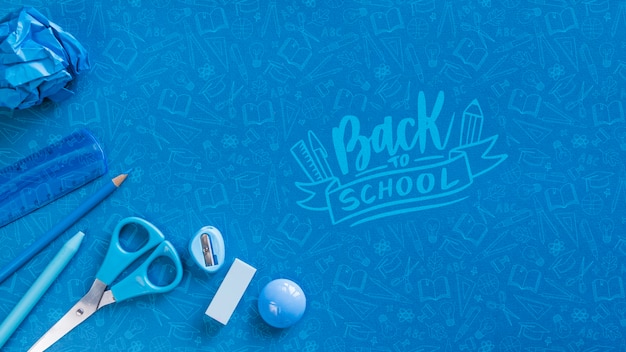 PSD flat lay arrangement with blue school supplies