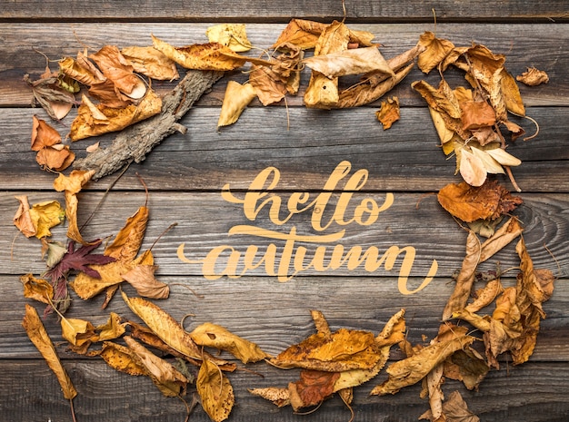 Flat lay of autumn leaves on wooden table