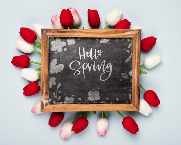 Flat lay of blackboard with spring tulips