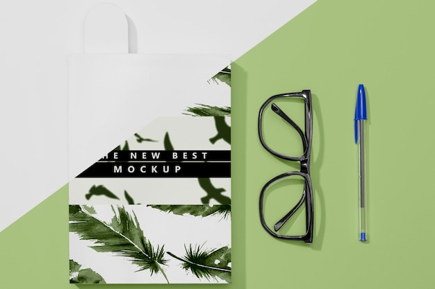 Flat lay book mock-up with glasses and pen