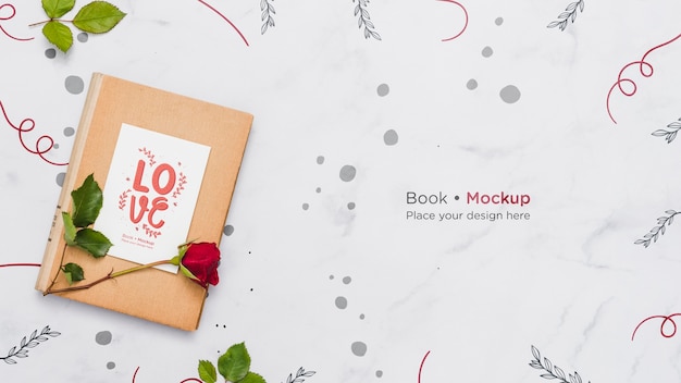 PSD flat lay of book with rose