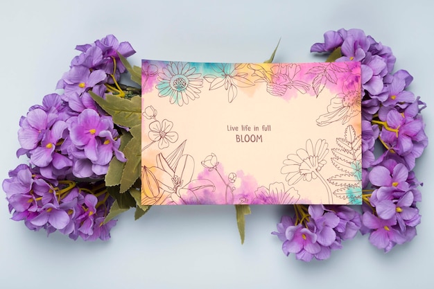Flat lay of card with spring flowers