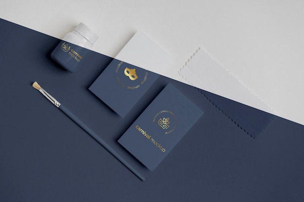 flat lay of carnival invitation with paint and brush