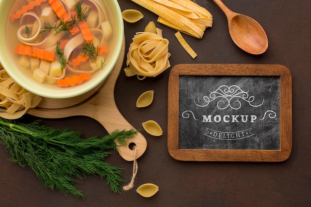flat lay of chalkboard with bowl of soup