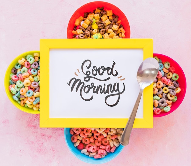 Flat lay of colorful cereals spoon and frame on plain background