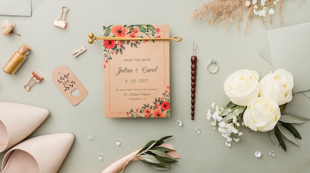 PSD flat lay composition of wedding elements with card mock-up