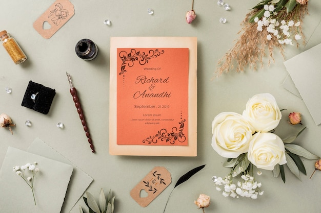 Flat lay composition of wedding elements with invitation mock-up