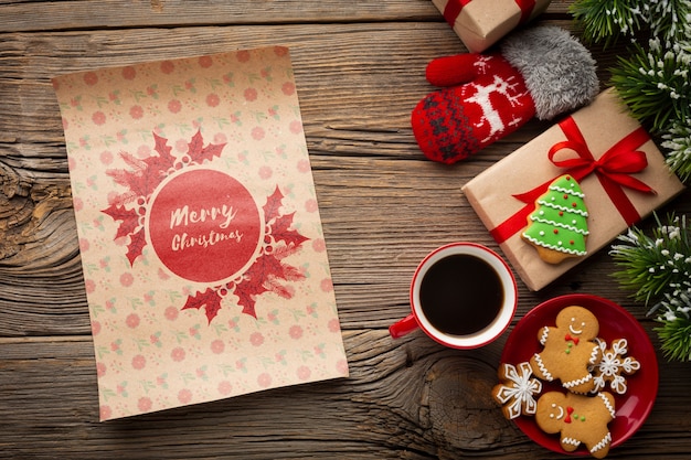 Flat lay cup of coffee with gingerbread and christmas gifts