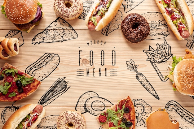 Flat lay of delicious fast food on wooden table