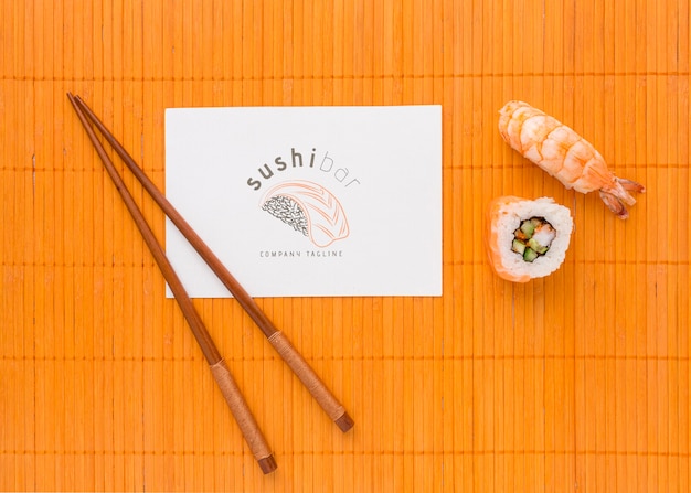 PSD flat lay delicious sushi with sticks