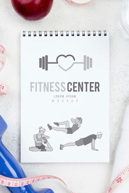 PSD flat lay of fitness notebook with measuring tape and apple