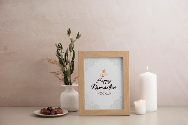 Flat lay of frame mockup with candle, sweets and leaves