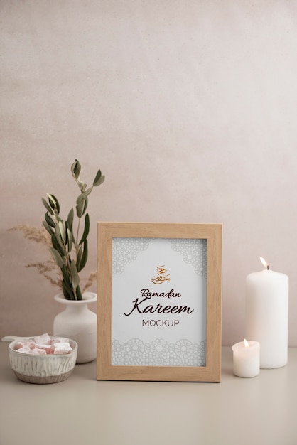 PSD flat lay of frame mockup with candle, sweets and leaves