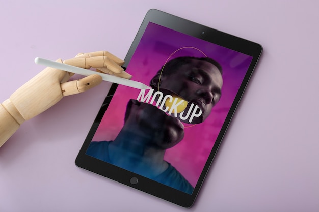 Flat lay model holding pencil and tablet mockup