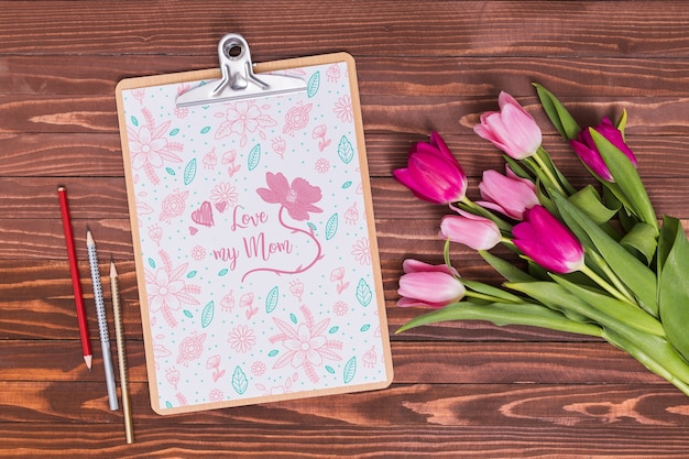 Flat lay mothers day composition with clipboard mockup