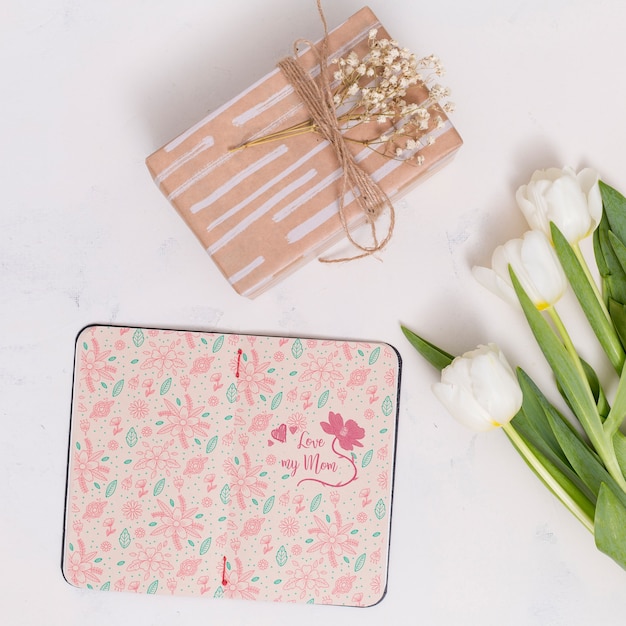 Flat lay mothers day composition with open book mockup