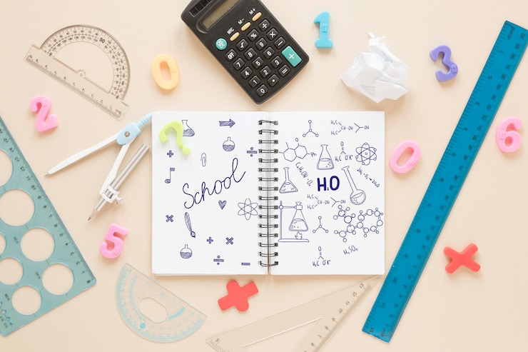 PSD flat lay of notebook with calculator and rulers