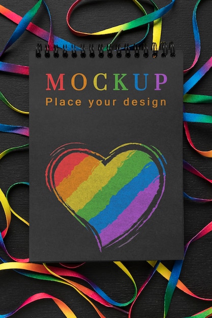 Flat lay of notebook with rainbow heart for diversity