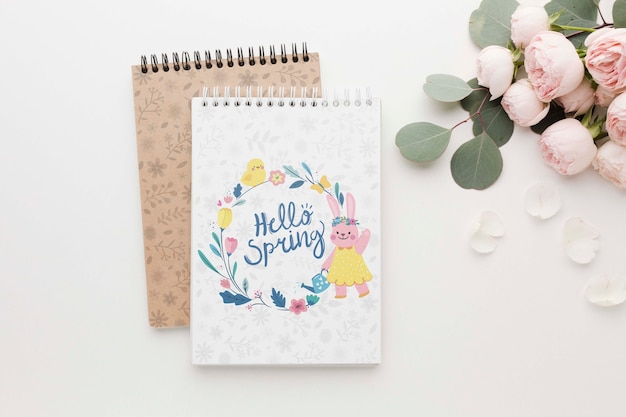 PSD flat lay of notebooks with spring roses