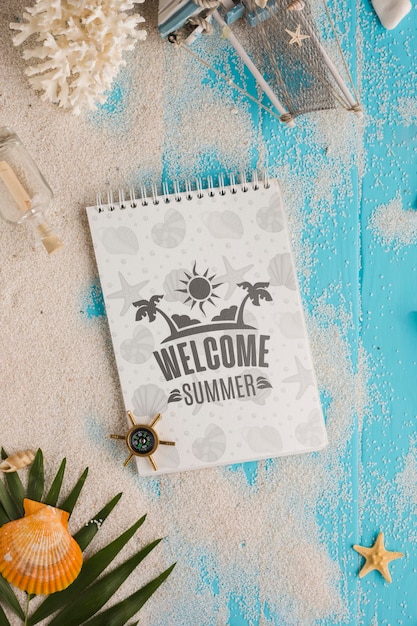 Flat lay notepad and sand on the table