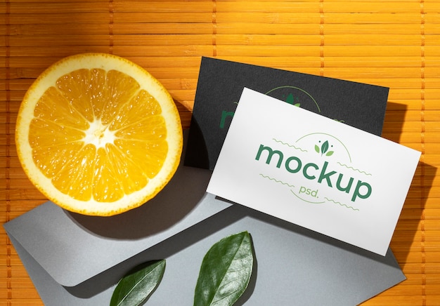 Flat lay of paper stationery with citrus and leaves