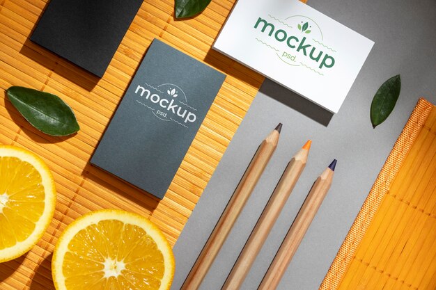 Flat lay of paper stationery with citrus and pencils