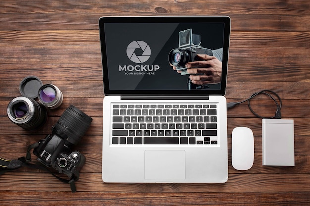 Flat lay of photographer wooden workspace with laptop