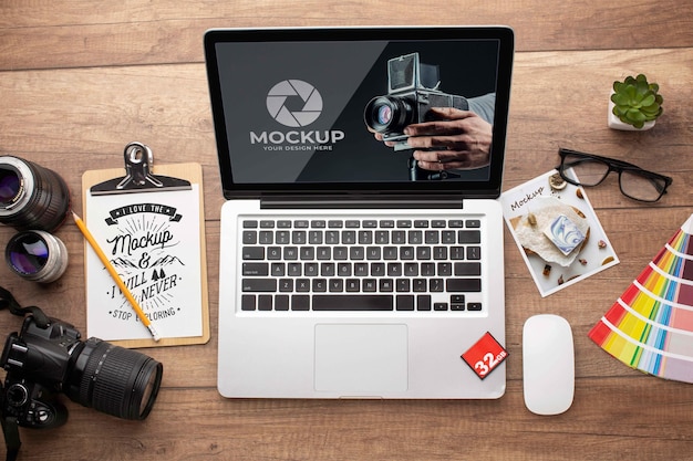 Flat lay of photographer wooden workspace with laptop