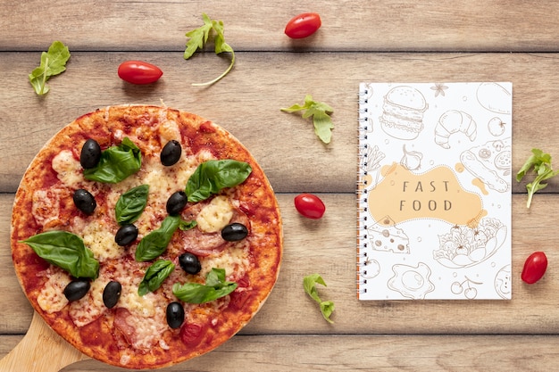 Flat lay of pizza on wooden background