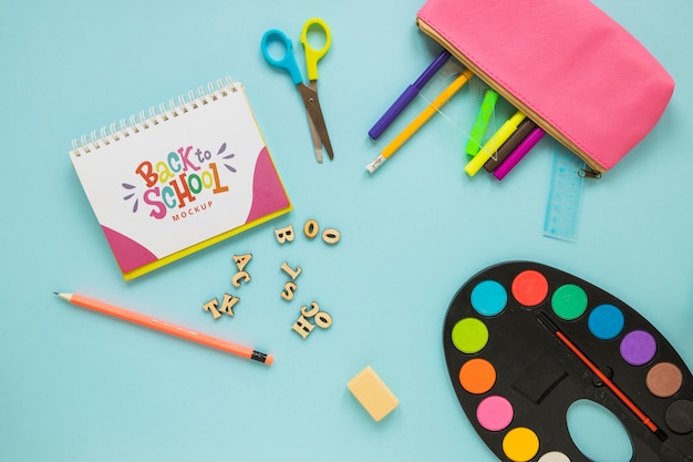 Flat lay school supplies on blue background