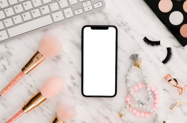 Flat lay smartphone mock-up with make-up brushes