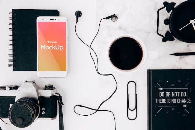 Flat lay smartphone mockup on workspace