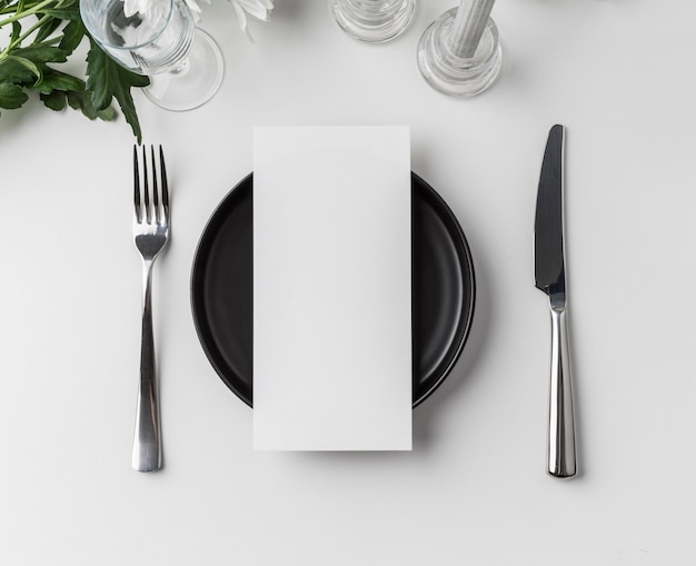 Flat lay of table arrangement with spring menu mock-up and cutlery