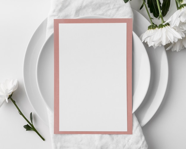 Flat lay of table arrangement with spring menu mock-up and plates