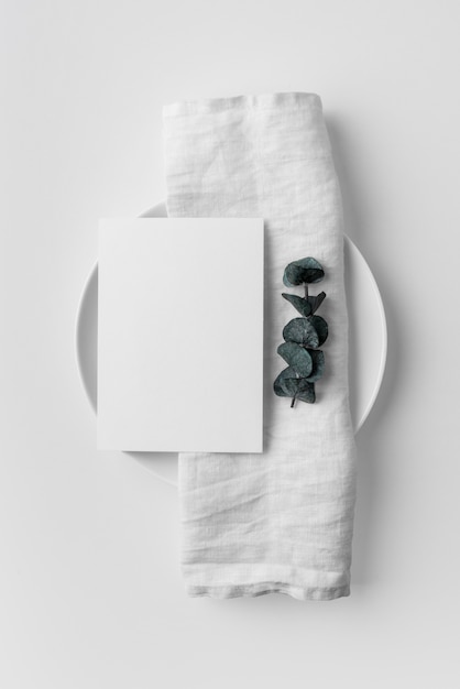 Flat lay of table arrangement with spring menu mock-up and towel on plate