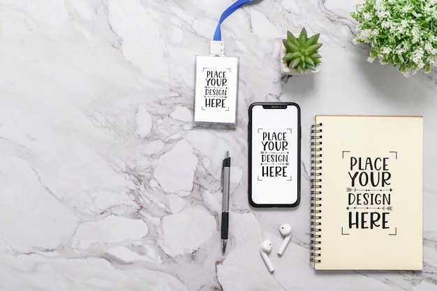 Flat lay Top view Blank Mockup smartphone display and tag with cover book on Office Desk with pen earphone and plant Empty space for insert your design copy space