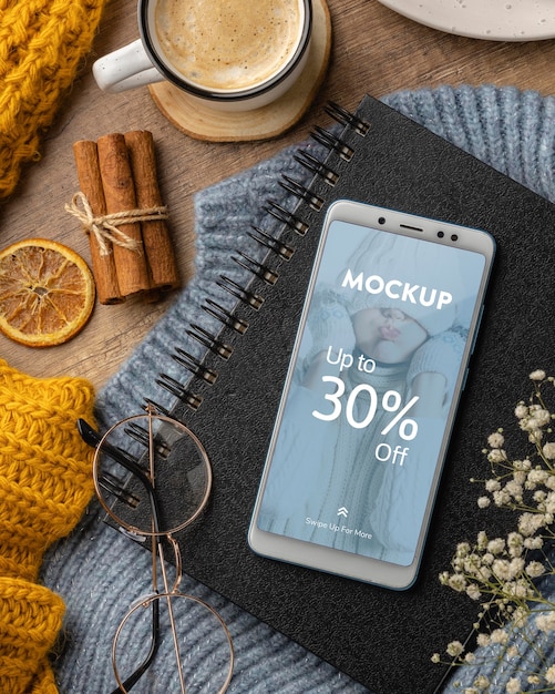 Flat lay winter hygge arrangement with phone mock-up