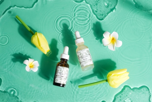 Floral set with mockup bottles of natural lotion and flowers.