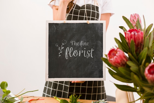 Florist holding mock-up sign