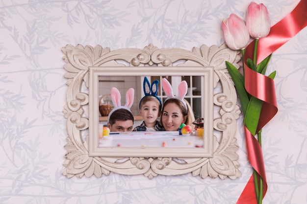 PSD flowers beside frame with easter family photo