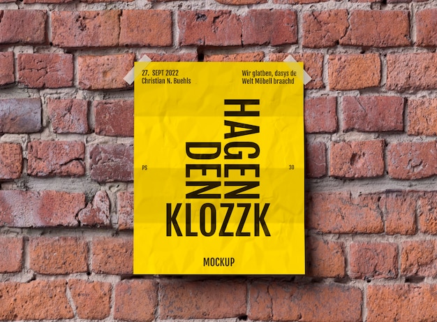 PSD folded poster mock-up on brick surface