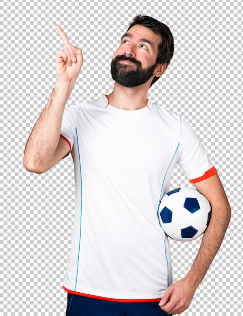 Football player holding a soccer ball pointing up