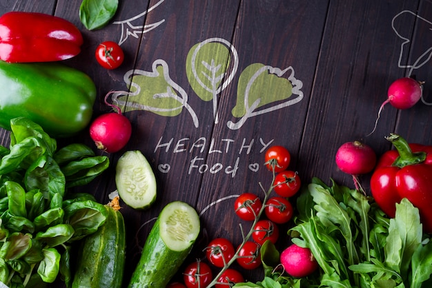 Frame of different health vegetables on a wooden background